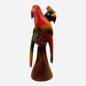 Carved Vintage Wooden Parrots On A Tree Stump